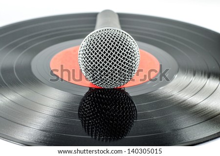 Microphone on old disc isolated on  white background - music concept -