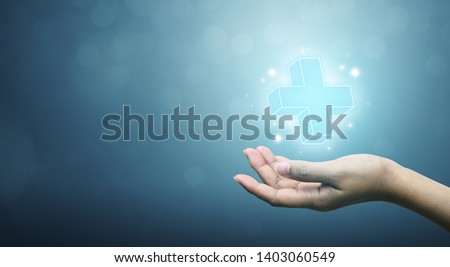 Hand holding plus sign virtual means to offer positive thing (like benefits, personal development, social network, health insurance) with copy space Royalty-Free Stock Photo #1403060549