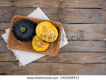 
	
Green pumpkin isolated on the wood background 				