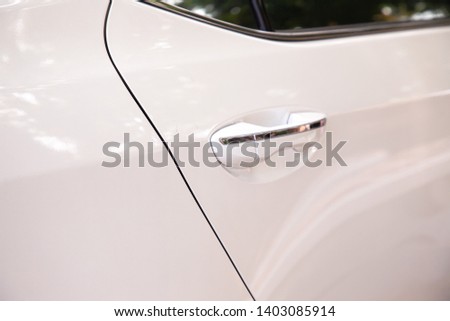 Door handle of car, rear window.