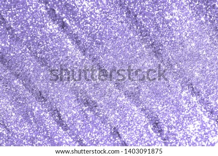 fantastic purple glossy sand made of silver glitters with selective focus and small bokeh texture - abstract photo background