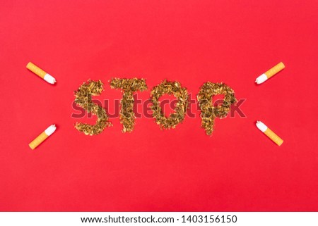inscription stop from tobacco and cigarette butt. World no tobacco day concept. Top view.