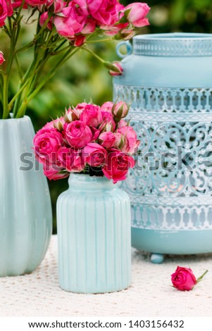 Bouquet of pink roses in blue ceramic vase. Postcard motif. 