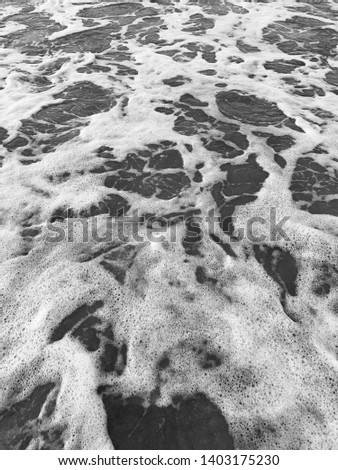 Waves receding from sandy beach