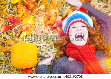 portrait of a young beautiful redhead woman with blue eyes on sunny october day with sunny shine