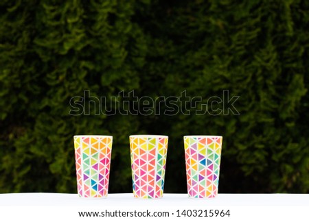 bright colorful glasses, dishes for a picnic, summer glasses. Copy space.
