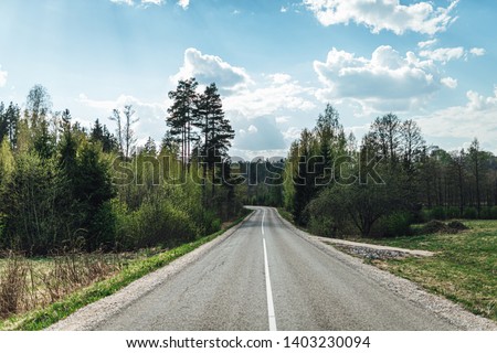 Empty rural countryside road in perspective view summer time.