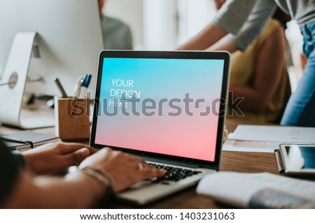 Office worker working on a laptop mockup Royalty-Free Stock Photo #1403231063