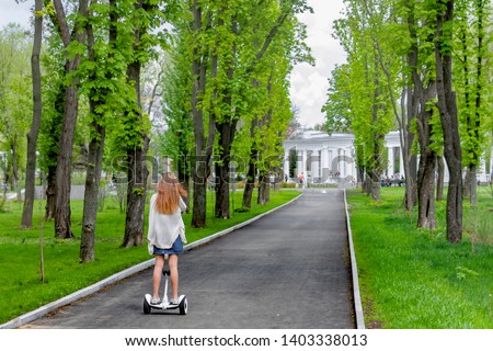 
Girl riding in a park on a hoverboard