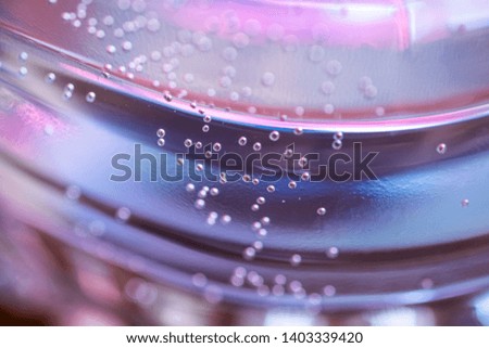 Small bubbles air in the water focus and unfocus. Bubbles macro shot close-up. Abstract colorful Background