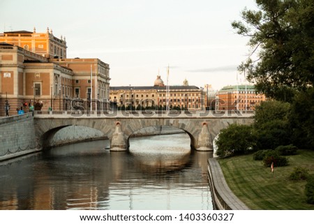 Landscape in center of Stockholm with water canal and bridge, sunset time. Old Stockholm cityscape, ancient buildings on background.