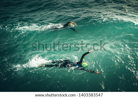 Swimmers swim during Swimming Competition in the Sea. Open water sport race