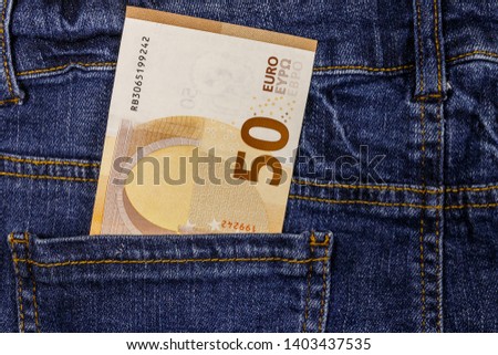 Fifty euro banknote in the pocket of blue jeans