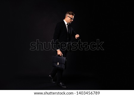 Full length body size view of nice elegant classy busy attractive content director leader marketer expert economist recruitment looking at watch cv resume interview isolated over black background
