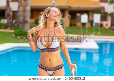 Blonde woman in bikini at pool