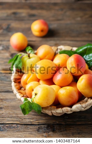 Sweet apricots on the wooden table, rustic style and slective focus image