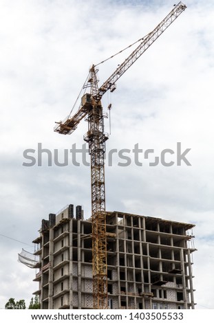 Tower crane at the construction site of a multistory building.