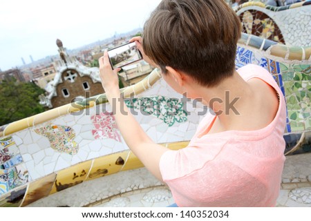 Girl taking picture of Barcelona from Guell Park