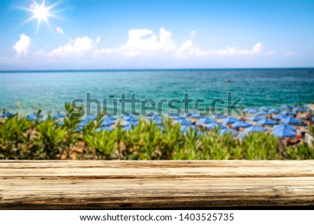 Wooden desk of free space for your decoration and summer landscape of beach and sea 