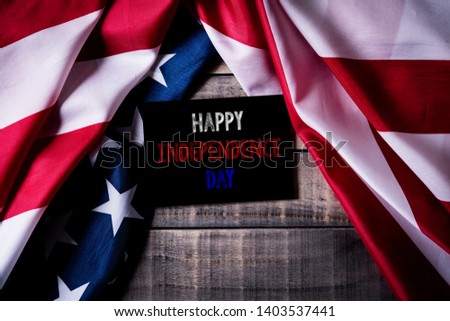 Top view of white picture frame with Flag of the United States of America on wooden background.  Independence Day USA, Memorial.