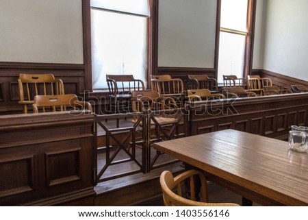 Jury Box And Defendant Table. Small rural county courthouse interior with juror box and table for defendant. Royalty-Free Stock Photo #1403556146