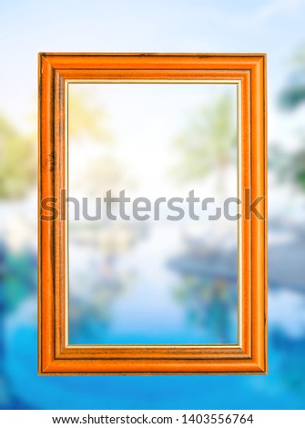 Empty woodden vintage frame with blurry blackground  swimming pool and the blue sea with palm,coconut trees with background white clouds and blue sky,  peacful and realax,