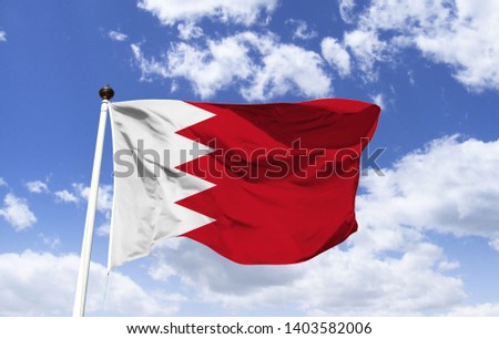 Bahrain flag template floating under a blue sky. Country in the Middle East, more than 30 islands in the Persian Gulf. In modern Capital Manama, Bahrain's acclaimed museum and Bahrain Fort.