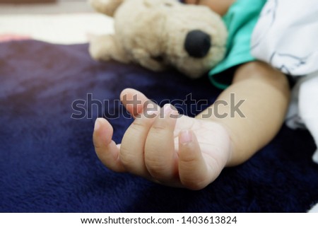 Children sleep on a dog doll The arms of the child are gentle and relaxed.