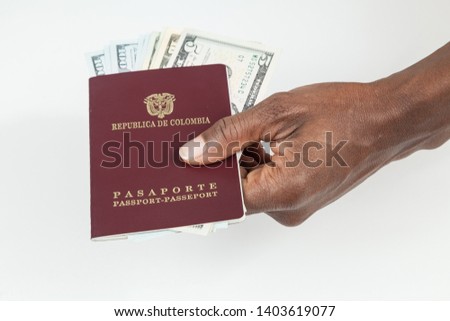 Travel concept, Colombian passport with dollar bills for travel abroad.