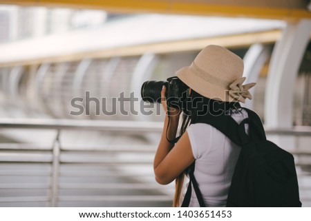 Tourist Photographing While Standing On Bridge