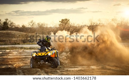 Racing in the sand on a four-wheel drive quad. Royalty-Free Stock Photo #1403662178