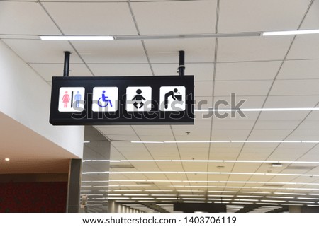 Public Toilet Sign board hanging with ceiling in the Airport