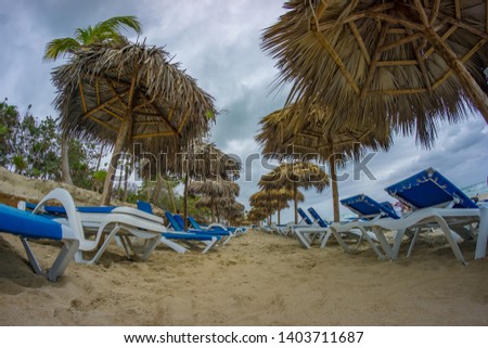 Rows of sun beds at the beautiful beach of Varadero in Cuba at rainy and stormy day