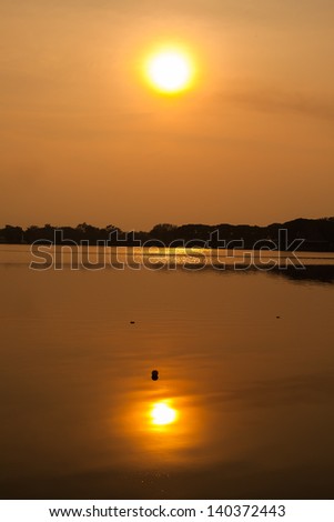 silhouette sunset over lake background.