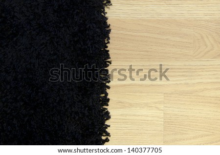 Black carpet and wooden surface