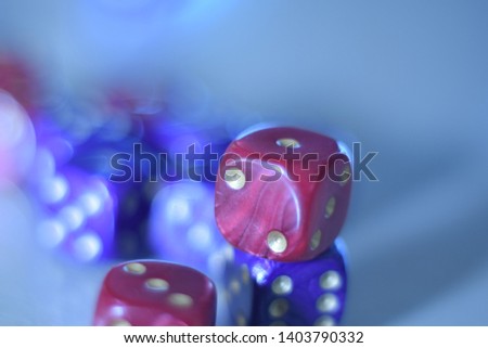 Red and blue dice macro close up picture on light blue background