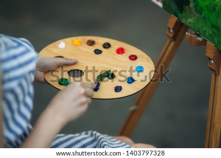 Palette with paints and spatula. Drawing a picture