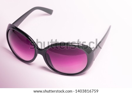 A pair of vintage colored sunglasses for women and with thick frames isolated on a white uniform background