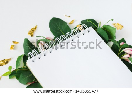 
Stylish floral branding notepad to display your artworks. Cute  mock up sketchbook on white background. Flat lay top view.
