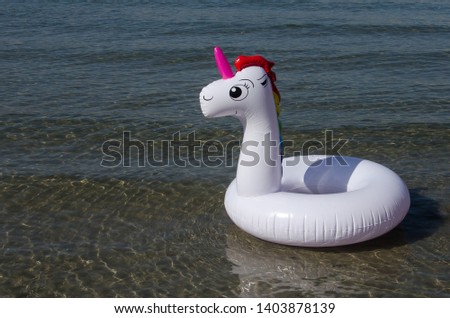 Unicorn inflatable float on sea. Inflatable unicorn. Unicorn pool ring, unicorn pool float.