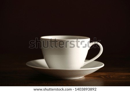 tea in a white Cup is on the table at night