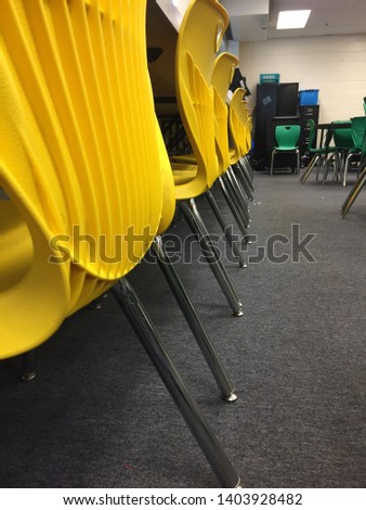 A line of yellow chairs in a carpeted room