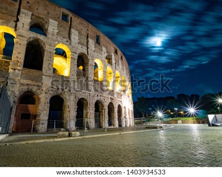 A night time picture of Oval amphitheatre in the centre of the city of Rome, Italy with light and full moon with no people
