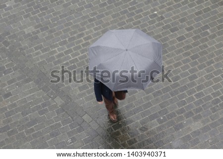 Walking with umbrella under the rain