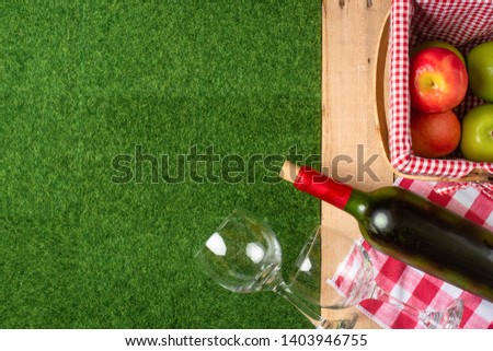 Summer picnic on the grass with a checkered tablecloth and healthy food, flat banner, Flat lay.Recreation and vacation.