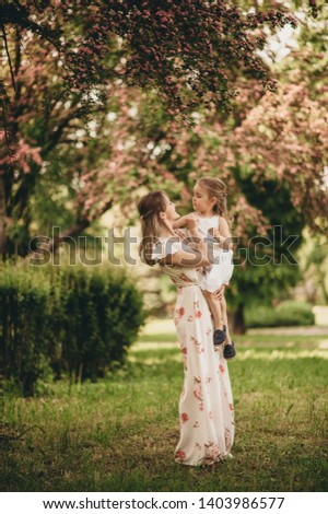 family photos, mom and daughter on the streets of the city, mom and baby in white dress with green grass background, emotional family photos of mom and daughter, funny photos running and fooling