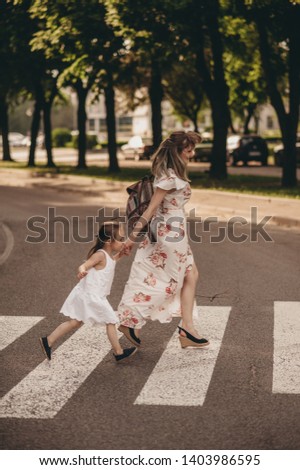 family photos, mom and daughter on the streets of the city, mom and baby in white dress with green grass background, emotional family photos of mom and daughter, funny photos running and fooling
