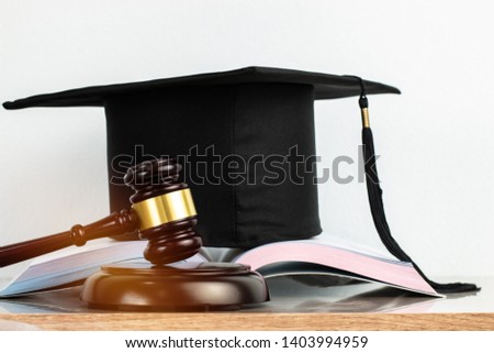 Judge gavel school lawyer on open book in library with diploma hat on wooden desk.Concept of Education Graduation study international legal rights, jurisprudence laws in university Royalty-Free Stock Photo #1403994959