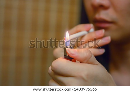 Human hand holding cigarette on brown background. Quit smoking for life on World no Tobacco day concept. No smoking concept. Just say NO to STOP Smoking.