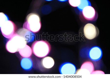 Beautiful bokeh light in the dark. Defocused at the colorful light decorating during festival such as Christmas and New Year. Blurred and soft focus.